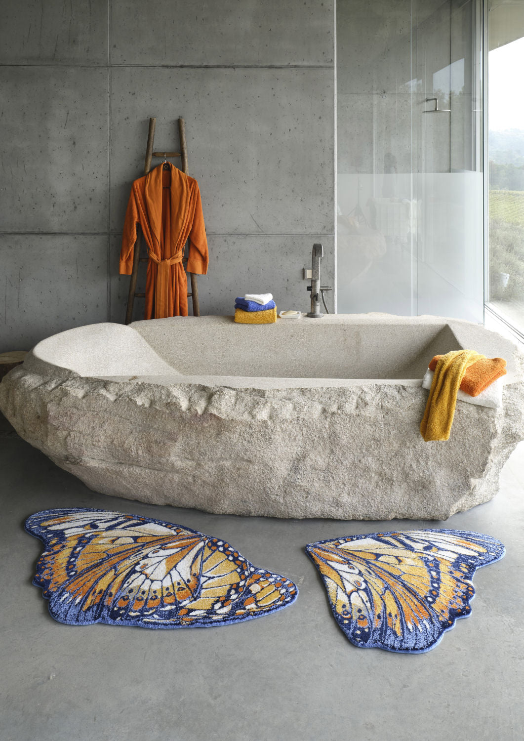 Luxusní koupelnová předložka Mariposa od Abyss & Habidecor ve tvaru detailně vykresleného oranžového a tmavě modrého motýlího křídla Waterfall Bathrooms